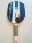 A vintage Ping Pong table tennis paddle with a blue and white face, featuring the number 3 and a portrait of Mahjong legend Wang Zhiqin, set against a plain light background.